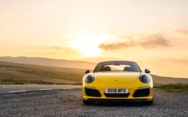 Front view of a yellow Porsche 911 Carrera T at sunset on a country road — 4K Ultra HD desktop wallpaper of a Porsche 911 sports car.