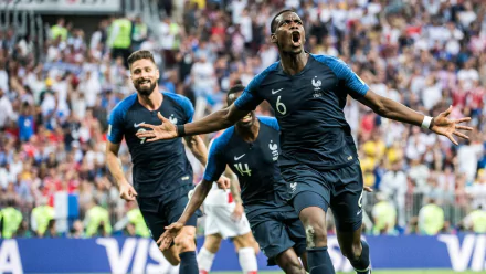 HD desktop wallpaper featuring football player Paul Pogba in celebration on the pitch, with a teammate behind him.
