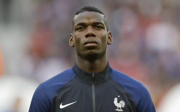 HD desktop wallpaper featuring a portrait of a sports player in a blue jersey with a Nike logo and the French national team emblem.
