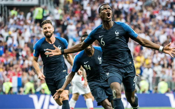 HD desktop wallpaper featuring football player Paul Pogba in celebration on the pitch, with a teammate behind him.