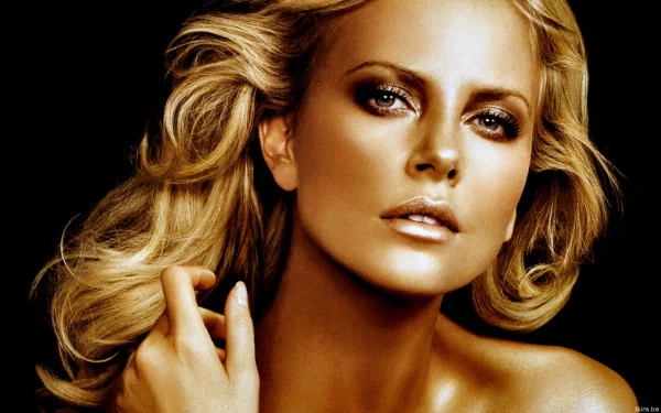 A stunning HD wallpaper featuring celebrity Charlize Theron, showcasing her striking features and glamorous appeal against a dark background.