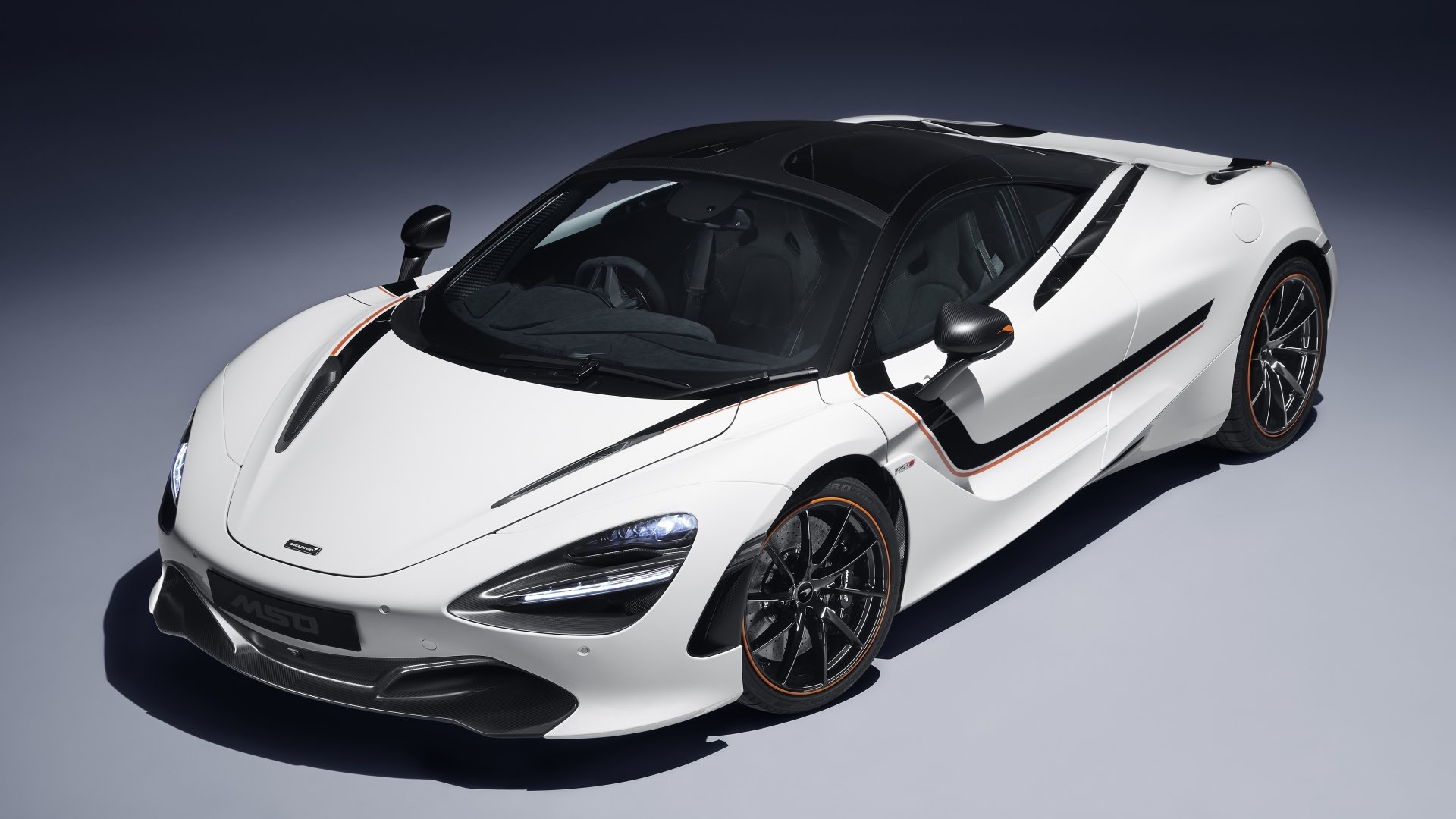 White McLaren 720S supercar angled to show sleek design and aerodynamic curves, featured in a 4K Ultra HD PC desktop wallpaper background.