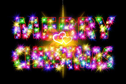 Vibrant, colorful Merry Christmas text with sparkling lights on a dark background, designed as a festive HD PC desktop wallpaper celebrating the holiday season.