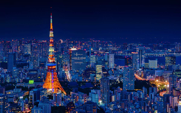 HD night cityscape wallpaper featuring the brightly lit Tokyo Tower surrounded by an expansive view of Tokyo, Japan.