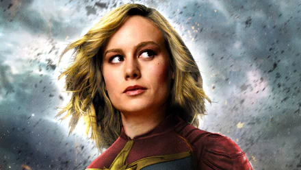 HD desktop wallpaper featuring Brie Larson as Captain Marvel against a stormy, dramatic sky background.