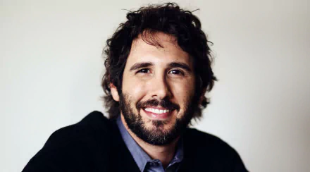 HD wallpaper featuring a smiling person with a beard, tagged as Josh Groban, with a neutral background, for desktop use.
