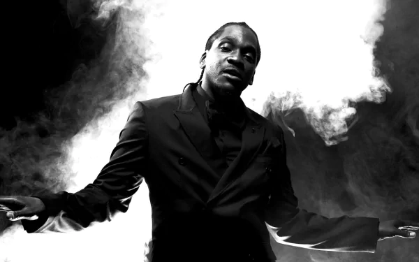 HD desktop wallpaper featuring a monochrome image of Pusha T with arms outstretched amidst swirling smoke.