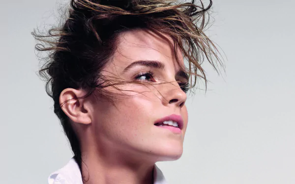 Close-up portrait of celebrity Emma Watson with windswept hair, captured in stunning 4K Ultra HD quality for a vibrant PC desktop wallpaper background.
