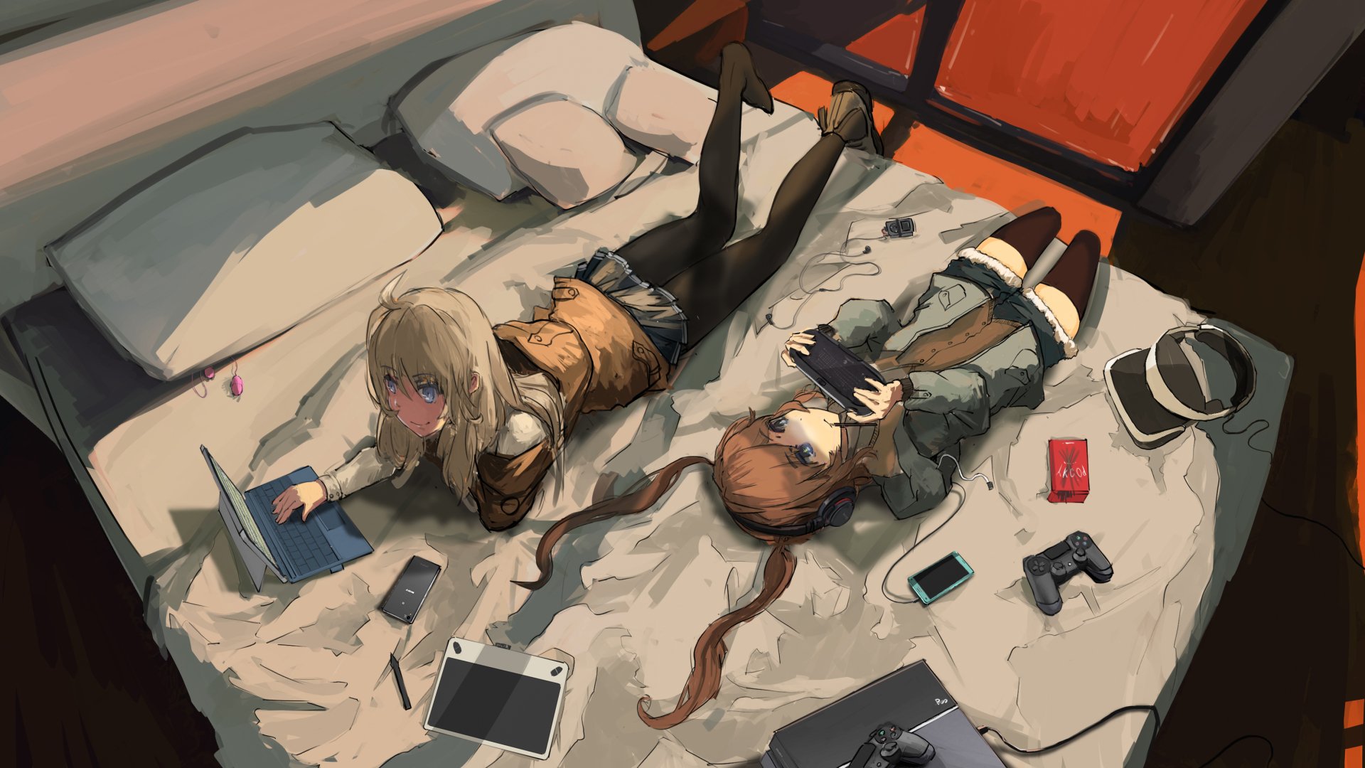 Anime-style HD desktop wallpaper featuring two girls with blue eyes and brown to blonde hair, lying on a bed with a laptop, tablet, and gaming accessories scattered around.