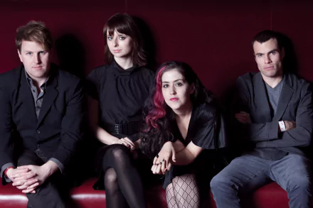 HD desktop wallpaper featuring the band Freezepop posing against a red background.