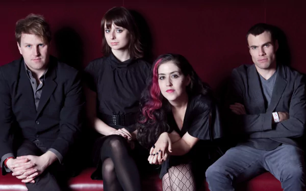 HD desktop wallpaper featuring the band Freezepop posing against a red background.