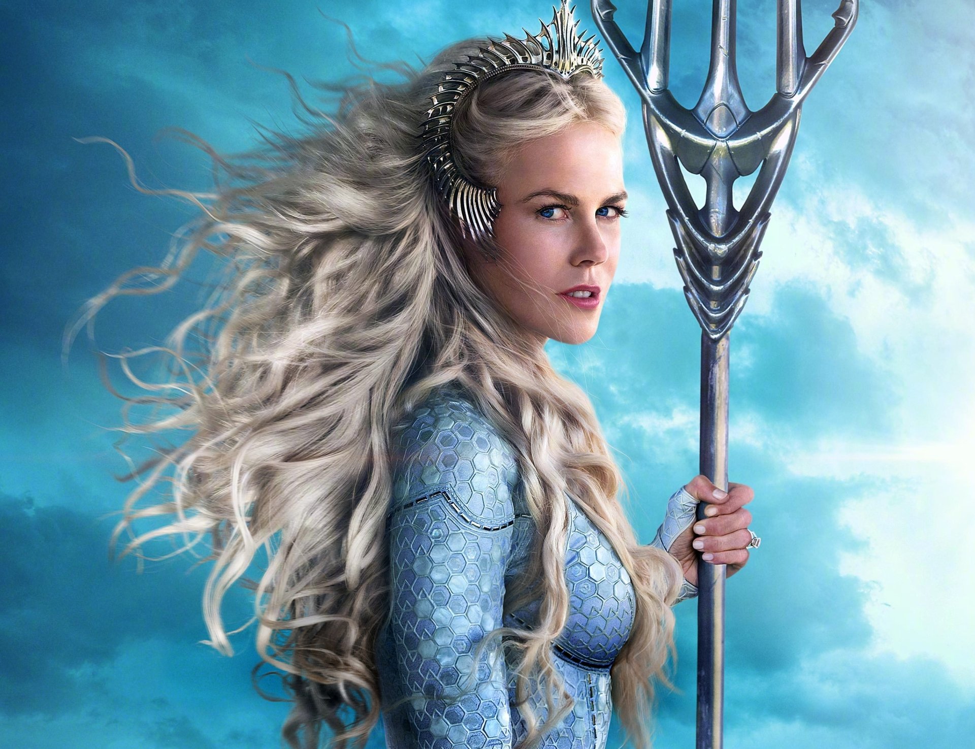 HD PC desktop wallpaper featuring Nicole Kidman as Queen Atlanna from the movie Aquaman, holding a trident against a cloudy blue sky background.