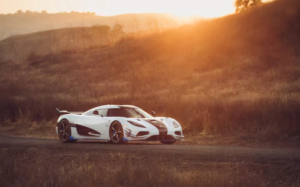 White Koenigsegg Agera supercar parked on a country road at sunset — dramatic 4K Ultra HD desktop wallpaper background.