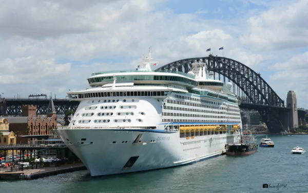 MS Explorer of the Seas cruise ship docked in Sydney, Australia with the Sydney Harbour Bridge looming behind — HD PC desktop wallpaper.