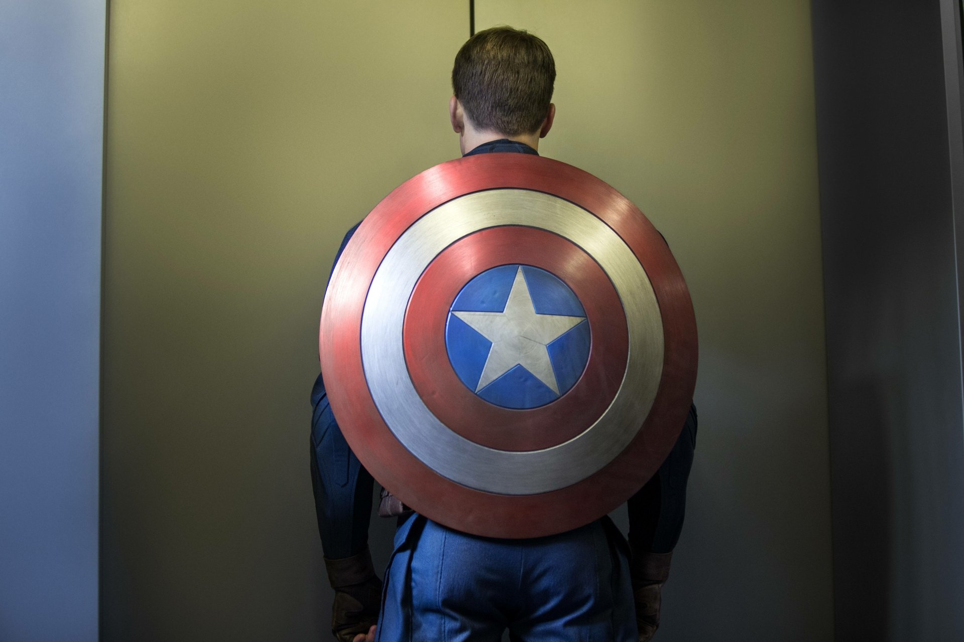 Rear view of Captain America from the movie Captain America: The Winter Soldier, bearing his iconic shield — 5K Ultra HD PC desktop wallpaper background.