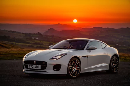 White Jaguar F-Type supercar parked on a coastal road at sunset, captured as a 4K Ultra HD PC desktop wallpaper background.