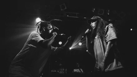 HD desktop wallpaper featuring a black and white photo of two rappers performing on stage, dynamic and energetic for music enthusiasts.