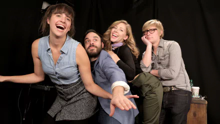 A vibrant, high-definition wallpaper featuring the band Lake Street Dive in a playful moment, showcasing their unique personality and musical energy against a dark backdrop.