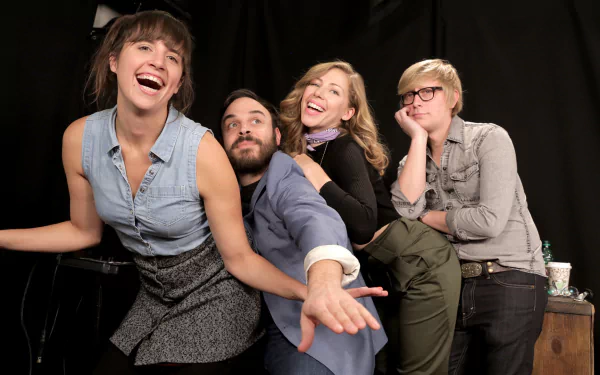 A vibrant, high-definition wallpaper featuring the band Lake Street Dive in a playful moment, showcasing their unique personality and musical energy against a dark backdrop.