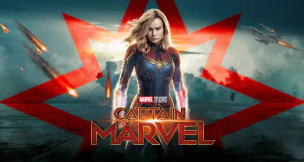 Brie Larson as Captain Marvel in a dynamic 4K Ultra HD movie wallpaper, featuring her iconic suit and a dramatic background with explosions and the Captain Marvel logo.