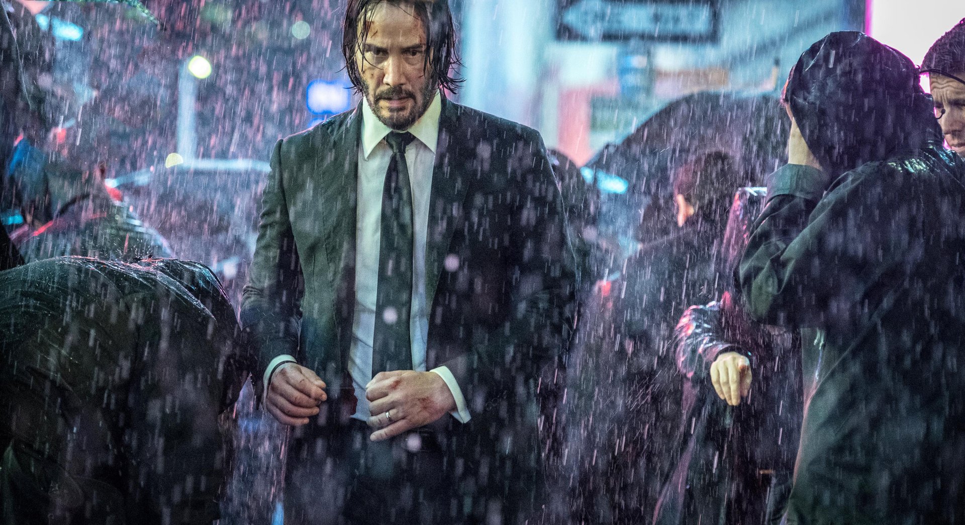 HD desktop wallpaper featuring Keanu Reeves as John Wick in a rain-soaked scene from the movie John Wick: Chapter 3 – Parabellum.
