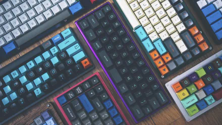 HD desktop wallpaper featuring an array of colorful mechanical keyboards arranged closely, highlighting technology through vibrant keycaps and sleek designs.