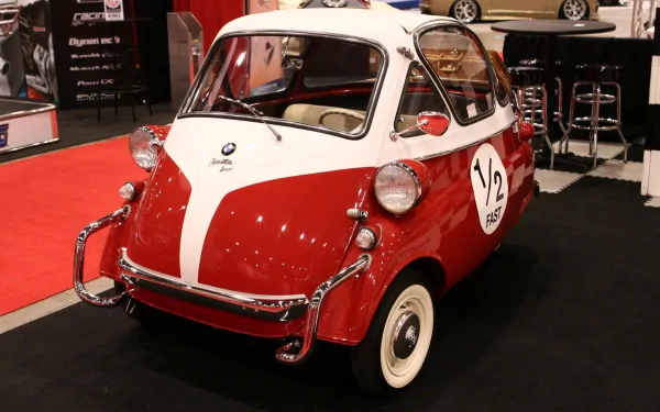 HD desktop wallpaper featuring a classic red and white BMW Isetta microcar displayed at an indoor auto show.