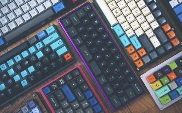 HD desktop wallpaper featuring an array of colorful mechanical keyboards arranged closely, highlighting technology through vibrant keycaps and sleek designs.