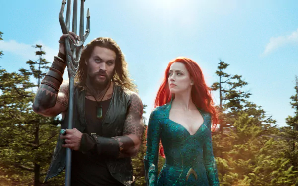 4K Ultra HD desktop wallpaper featuring Jason Momoa and Amber Heard from the movie Aquaman, with lush greenery and a bright sky in the background.
