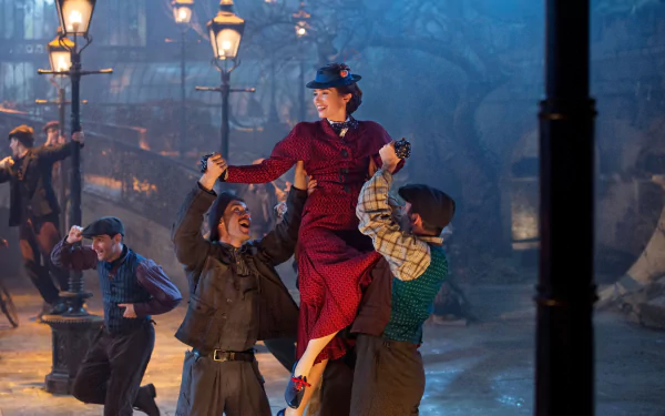HD desktop wallpaper from Mary Poppins Returns featuring the character being joyfully lifted by others at nighttime with lampposts.