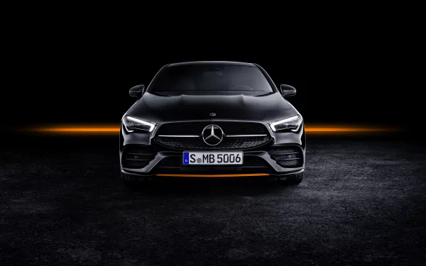 Front view of a silver Mercedes-Benz CLA-Class car with illuminated headlights, showcased as an 8K Ultra HD PC desktop wallpaper and background.