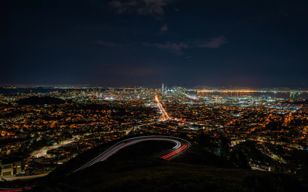 Nighttime cityscape of San Francisco, USA, showcasing illuminated streets and buildings in 8K Ultra HD quality as seen from an elevated viewpoint.
