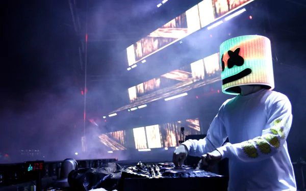 5K Ultra HD PC desktop wallpaper of an American electronic music DJ wearing a glowing marshmallow-shaped helmet, performing a live set with colorful LED screens and stage haze.