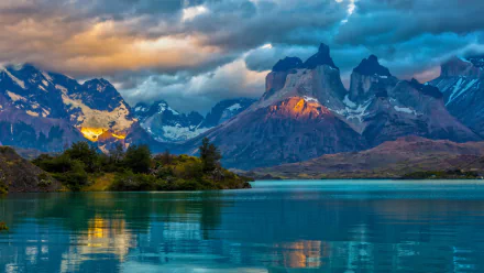 HD desktop wallpaper featuring Torres del Paine with striking mountains, vibrant lake, and dramatic clouds showcasing the stunning natural beauty of the region.