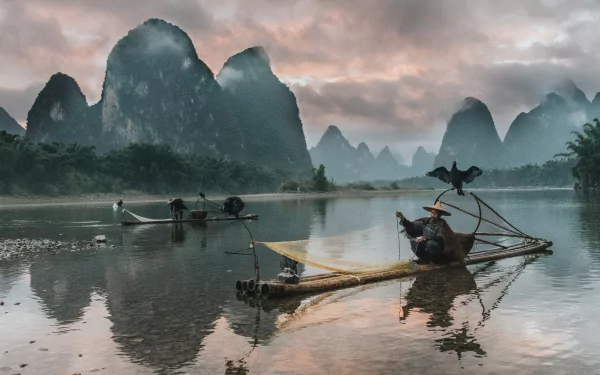A stunning 4K Ultra HD photograph capturing fishermen with cormorants on calm waters, set against dramatic karst mountains and a moody sky.