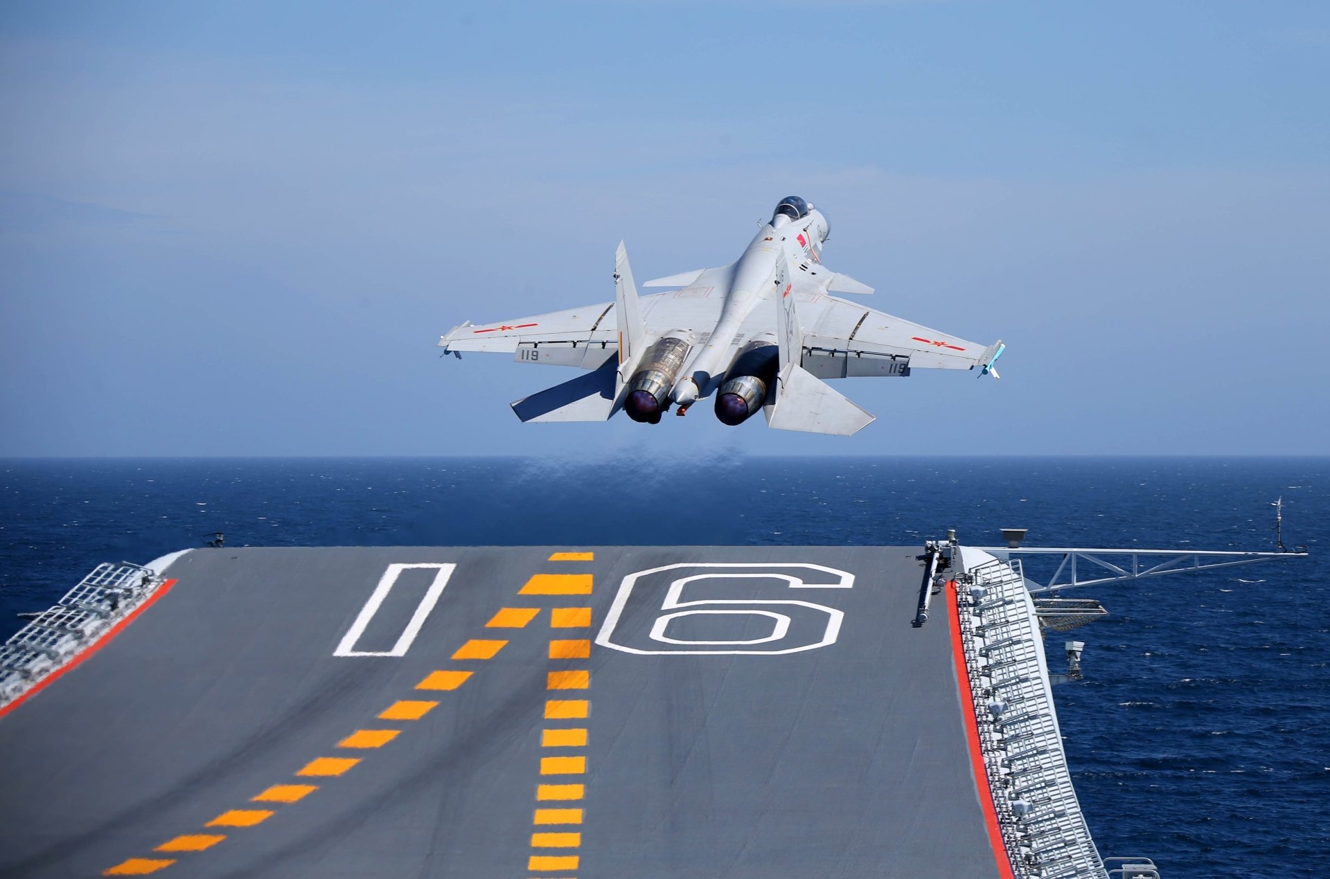 A Shenyang J-15 warplane, a military jet fighter, takes off from the deck of an aircraft carrier over the ocean in this 4K Ultra HD desktop wallpaper.