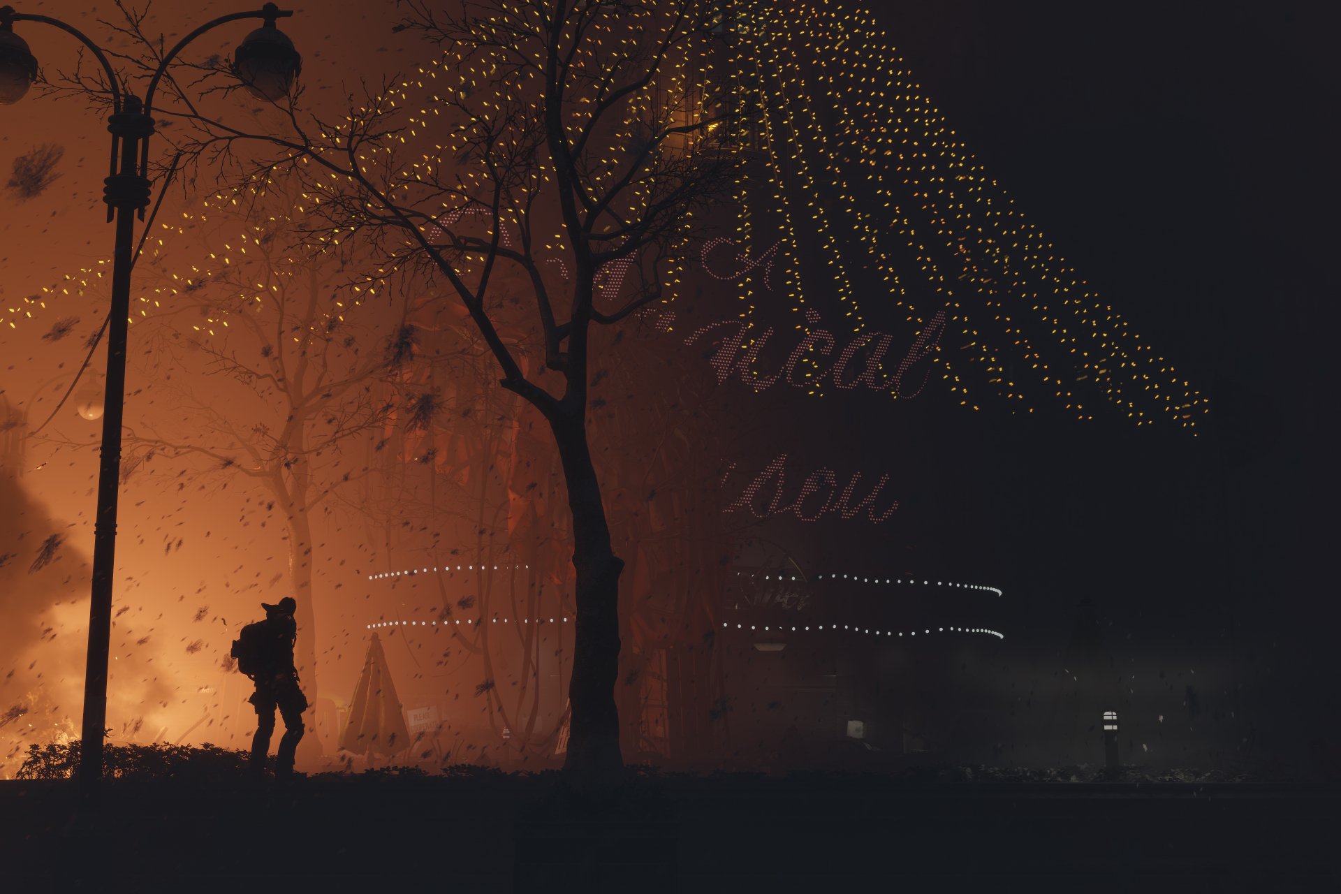 4K Ultra HD PC wallpaper featuring a dark, atmospheric scene from Tom Clancy's The Division 2 with a lone figure silhouetted against glowing orange light and string lights above.