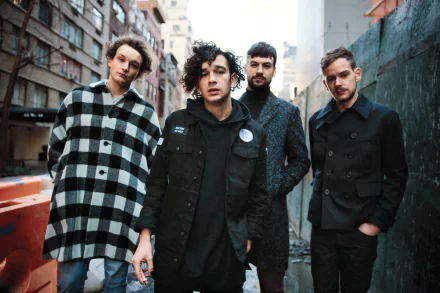 HD wallpaper of The 1975 band posing together on an urban street for a desktop background.