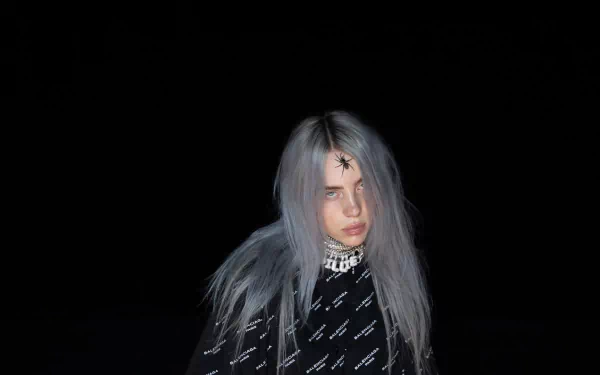 HD desktop wallpaper of Billie Eilish in a dark setting with striking grey hair and a patterned outfit.